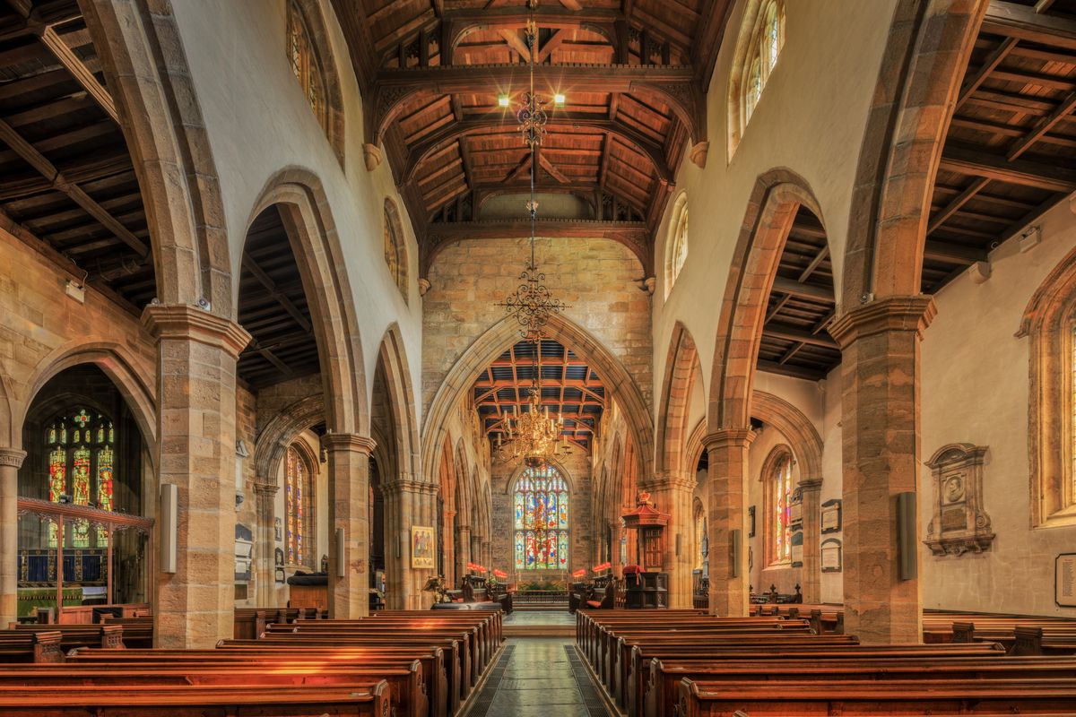 Interior of a historic English church with stone arches