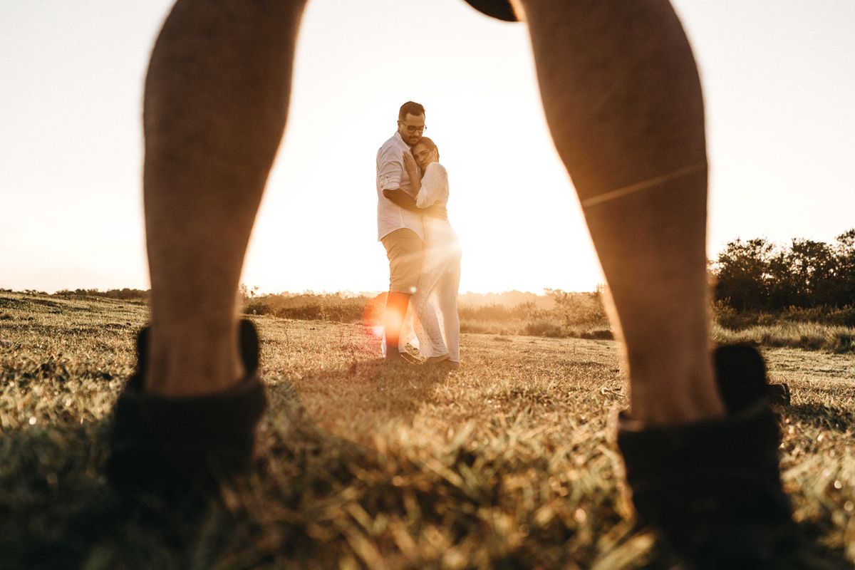 A couple enjoying a sunset walk in the countryside